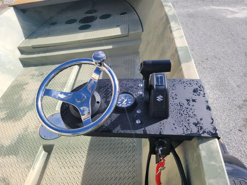 Slide: The Image of Steering console of a 2021 Hog Island Boat Works SW16 with Suzuki controls. - 4
