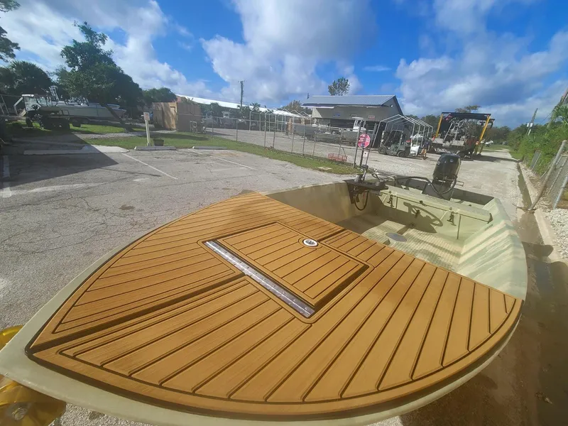 Slide: The Image of 2021 Hog Island Boat Works SW16 with wooden deck in a parking lot. - 9