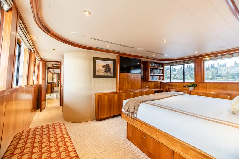 Slide: The Image of Luxurious master bedroom on a 2002 Westport Flybridge yacht with scenic window views. - 19