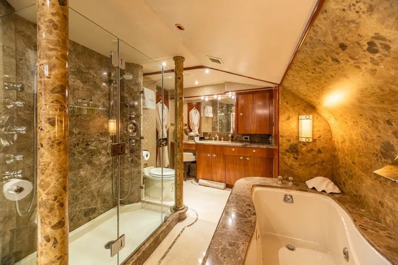 Slide: The Image of Luxurious bathroom on 2002 Westport Flybridge yacht with marble countertops and wooden cabinetry. - 21