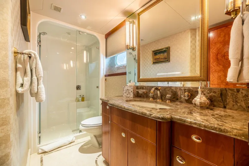 Slide: The Image of Luxurious bedroom on a 2002 Westport Flybridge yacht with elegant wood finishes. - 25