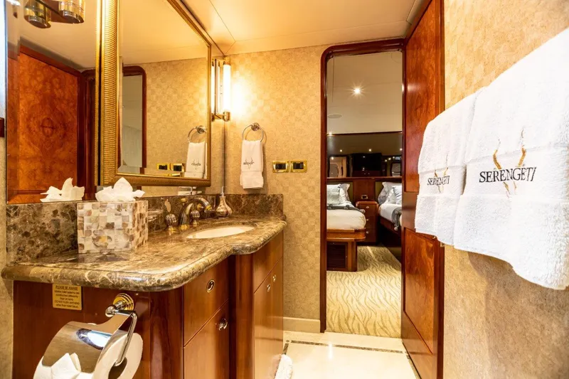 Slide: The Image of Luxurious twin bedroom on a 2002 Westport Flybridge yacht with elegant wood finishes. - 28