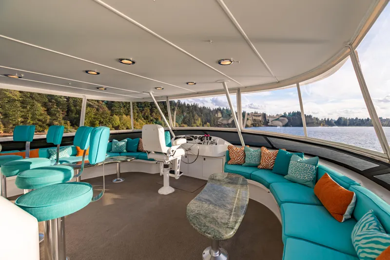 Slide: The Image of Luxurious 2002 Westport Flybridge yacht with spacious deck and turquoise seating. - 34