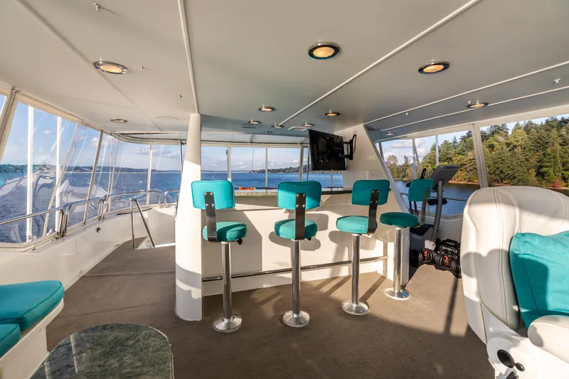 Slide: The Image of Luxurious 2002 Westport Flybridge with turquoise seating and scenic water views. - 35