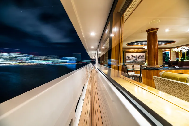 Slide: The Image of 2002 Westport Flybridge yacht with spacious deck and seating area on the water. - 6