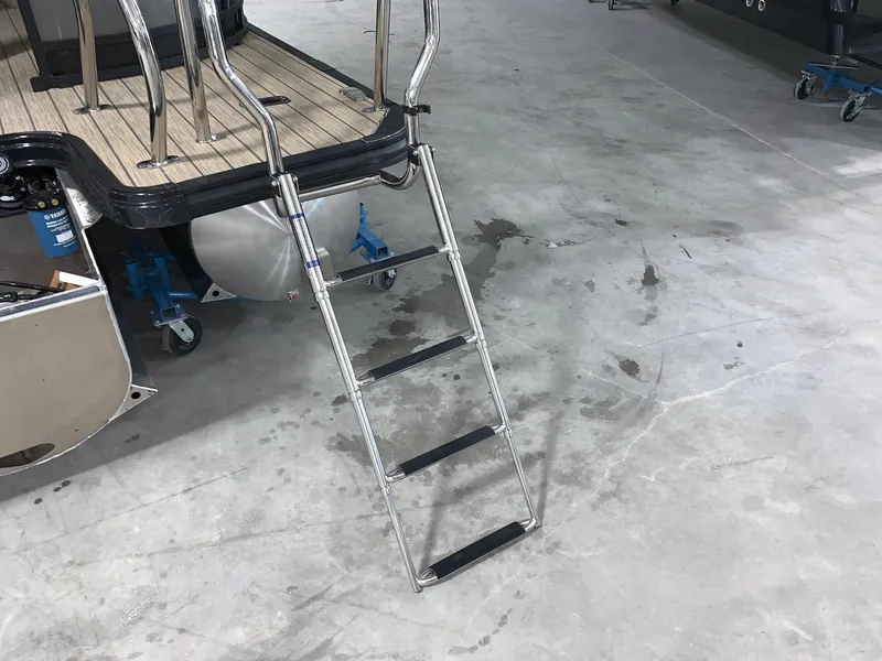 Slide: The Image of 2024 Starcraft SLS 3 DC boat with extended ladder on concrete floor. - 13