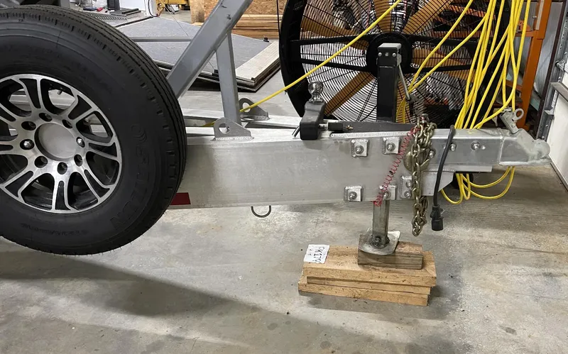 Slide: The Image of Trailer hitch of a Mystic 3800 model 2020 with spare tire and wooden blocks. - 13
