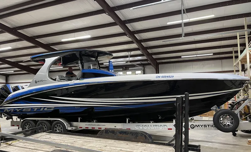 Slide: The Image of 2020 Mystic 3800 boat on trailer in indoor storage facility. - 2