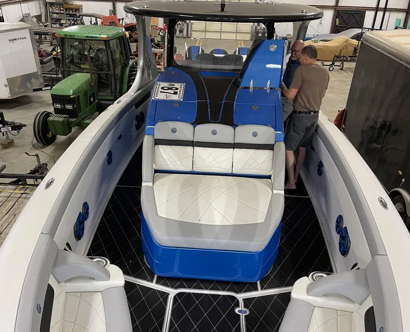 Slide: The Image of 2020 Mystic 3800 boat interior in a workshop with two people. - 20