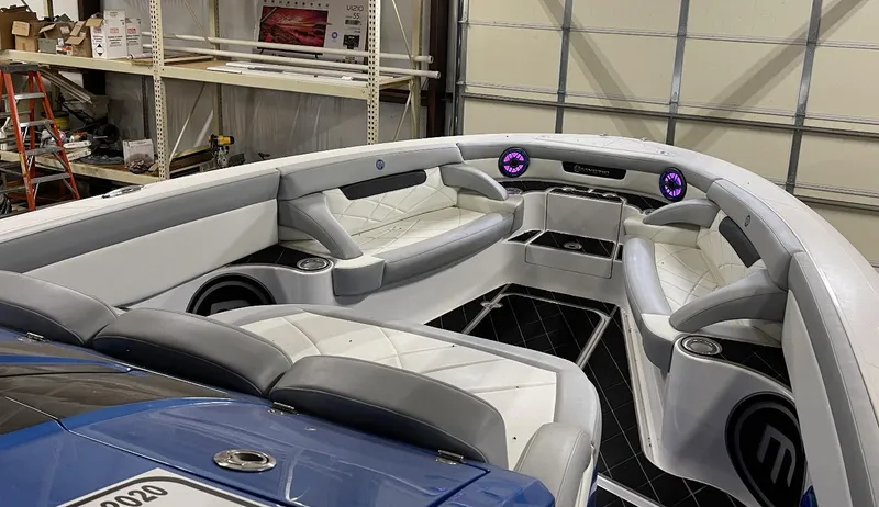 Slide: The Image of Interior of a 2020 Mystic 3800 boat with white and gray seating. - 21