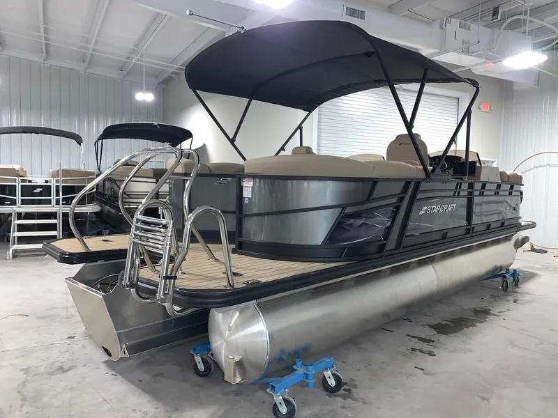 Slide: The Image of 2024 Starcraft SLS 3 DC pontoon boat in showroom. - 2