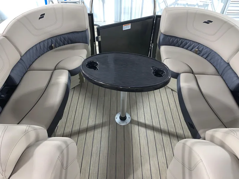 Slide: The Image of 2024 Starcraft SLS 3 DC boat interior with beige seating and a central table. - 5