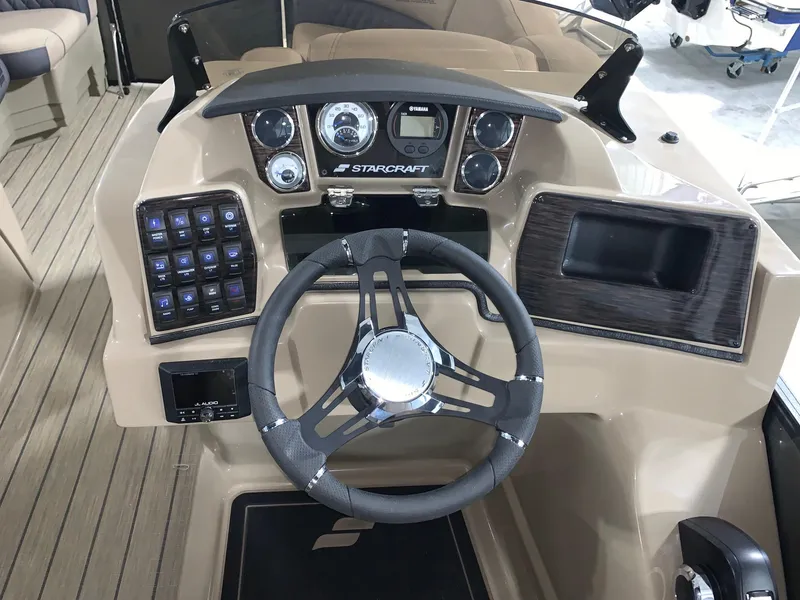 Slide: The Image of 2024 Starcraft SLS 3 DC boat dashboard with steering wheel and control panel. - 6