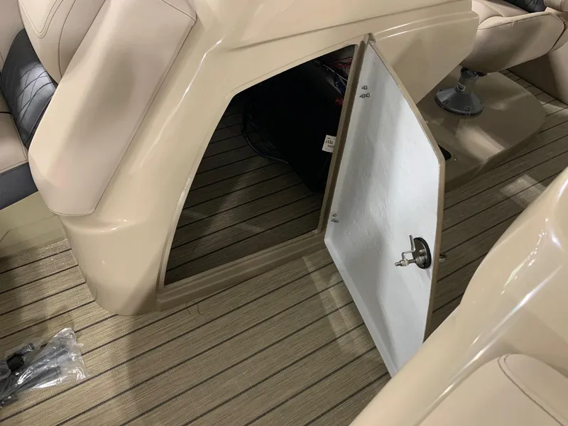 Slide: The Image of 2024 Starcraft SLS 3 DC boat interior storage compartment with open door. - 9