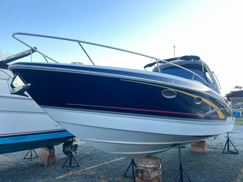 Slide: The Image of 2007 Formula 310 Sun Sport boat on stands outdoors. - 4