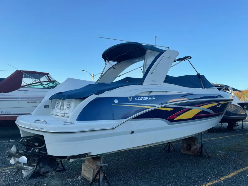 Slide: The Image of 2007 Formula 310 Sun Sport boat elevated outdoors. - 5