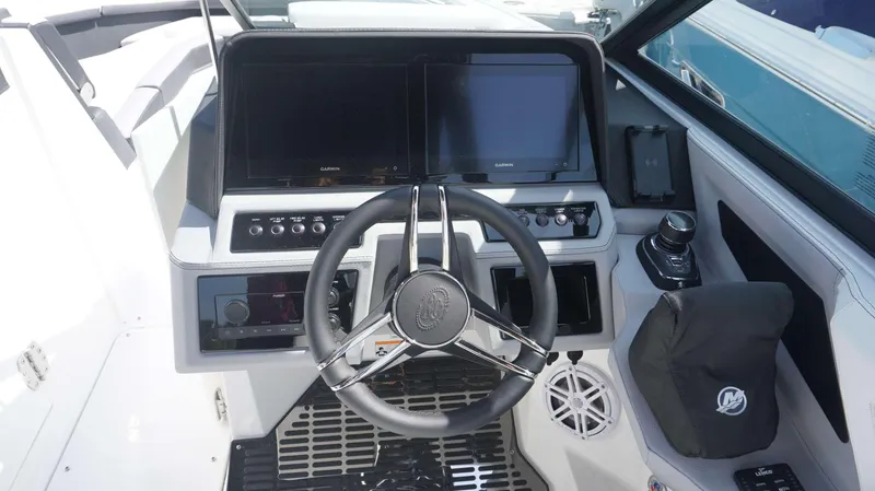 Slide: The Image of 2023 Cobalt R8 boat dashboard with steering wheel and digital displays. - 12