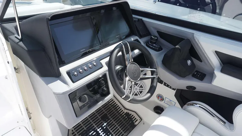 Slide: The Image of 2023 Cobalt R8 boat cockpit with modern steering wheel and dual display screens. - 13