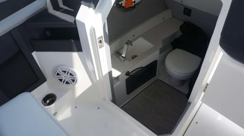 Slide: The Image of 2023 Cobalt R8 boat interior with sink, toilet, and speaker. - 23