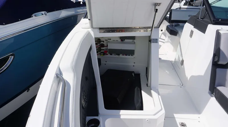 Slide: The Image of 2023 Cobalt R8 boat interior storage compartment open, showcasing spacious design and modern features. - 25