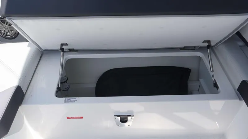 Slide: The Image of Open storage compartment in 2023 Cobalt R8 boat, showcasing interior space. - 28