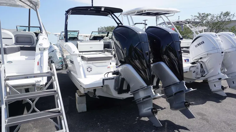 Slide: The Image of 2023 Cobalt R8 boat with dual outboard engines displayed in a marina setting. - 3