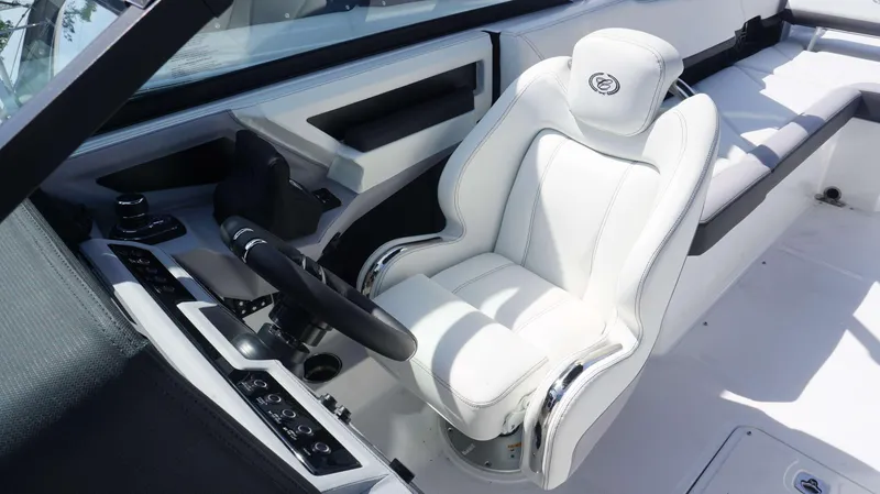 Slide: The Image of 2023 Cobalt R8 boat interior with white captain's seat and modern dashboard controls. - 8