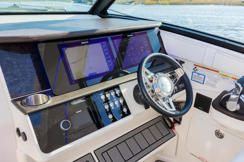 Slide: The Image of 2019 Sea Ray 320 Sundancer OB helm with dual navigation screens and steering wheel. - 37