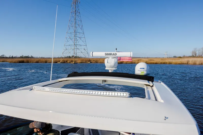 Slide: The Image of 2019 Sea Ray 320 Sundancer OB on a calm river with clear blue sky. - 45