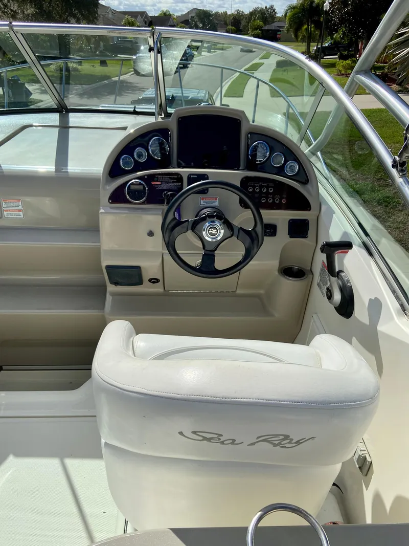 Slide: The Image of 2006 Sea Ray 270 Amberjack boat cockpit with steering wheel and dashboard controls. - 12