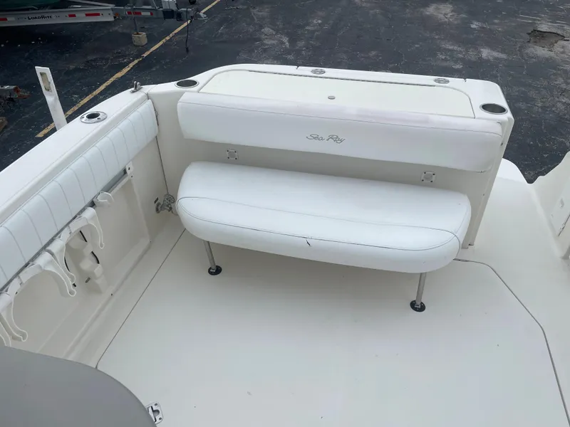 Slide: The Image of 2006 Sea Ray 270 Amberjack boat interior with white seating and rod holders. - 15