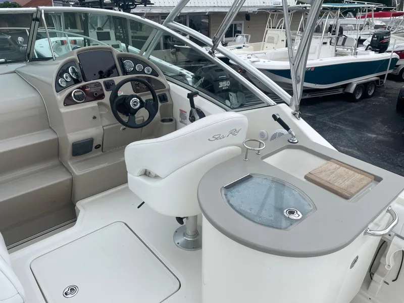 Slide: The Image of 2006 Sea Ray 270 Amberjack boat cockpit with steering wheel and control panel. - 16