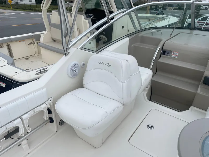 Slide: The Image of 2006 Sea Ray 270 Amberjack boat interior with white seating and helm area. - 17