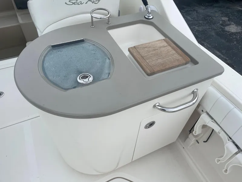 Slide: The Image of 2006 Sea Ray 270 Amberjack boat sink and cutting board station. - 20