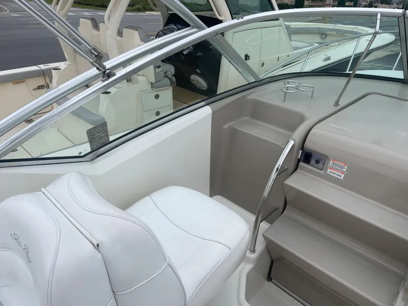 Slide: The Image of 2006 Sea Ray 270 Amberjack boat interior with white seating and helm area. - 22