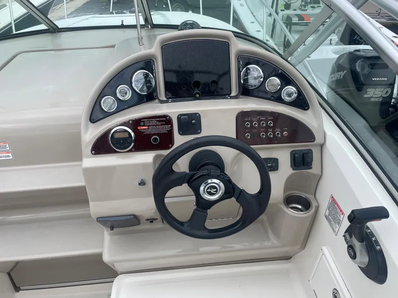 Slide: The Image of 2006 Sea Ray 270 Amberjack boat dashboard with steering wheel and instrument panel. - 23