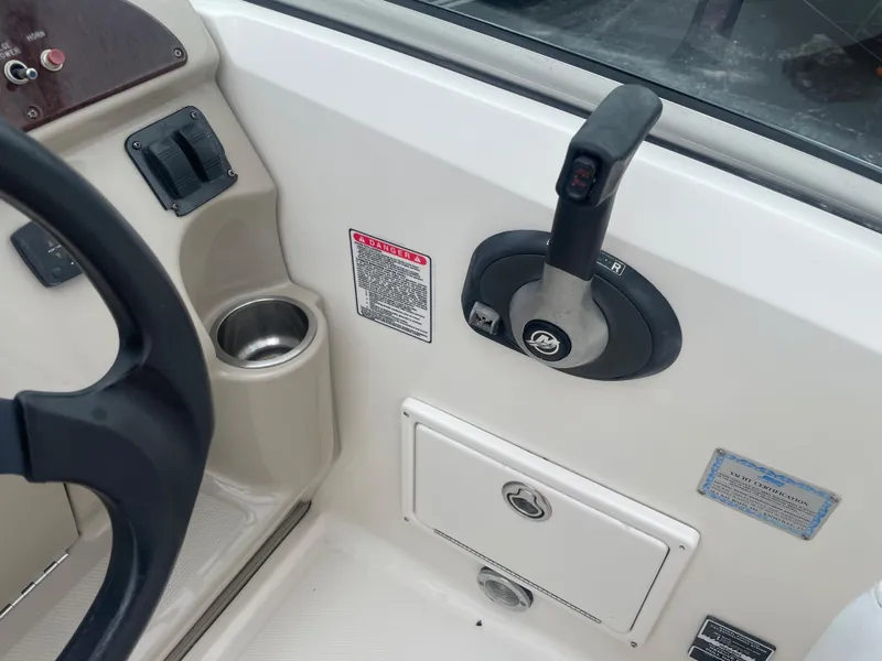 Slide: The Image of Close-up of 2006 Sea Ray 270 Amberjack boat controls and steering wheel. - 24