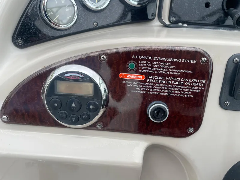 Slide: The Image of Control panel of 2006 Sea Ray 270 Amberjack with warning labels and buttons. - 27