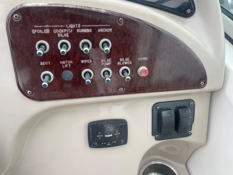 Slide: The Image of Control panel of a 2006 Sea Ray 270 Amberjack boat with various switches. - 28