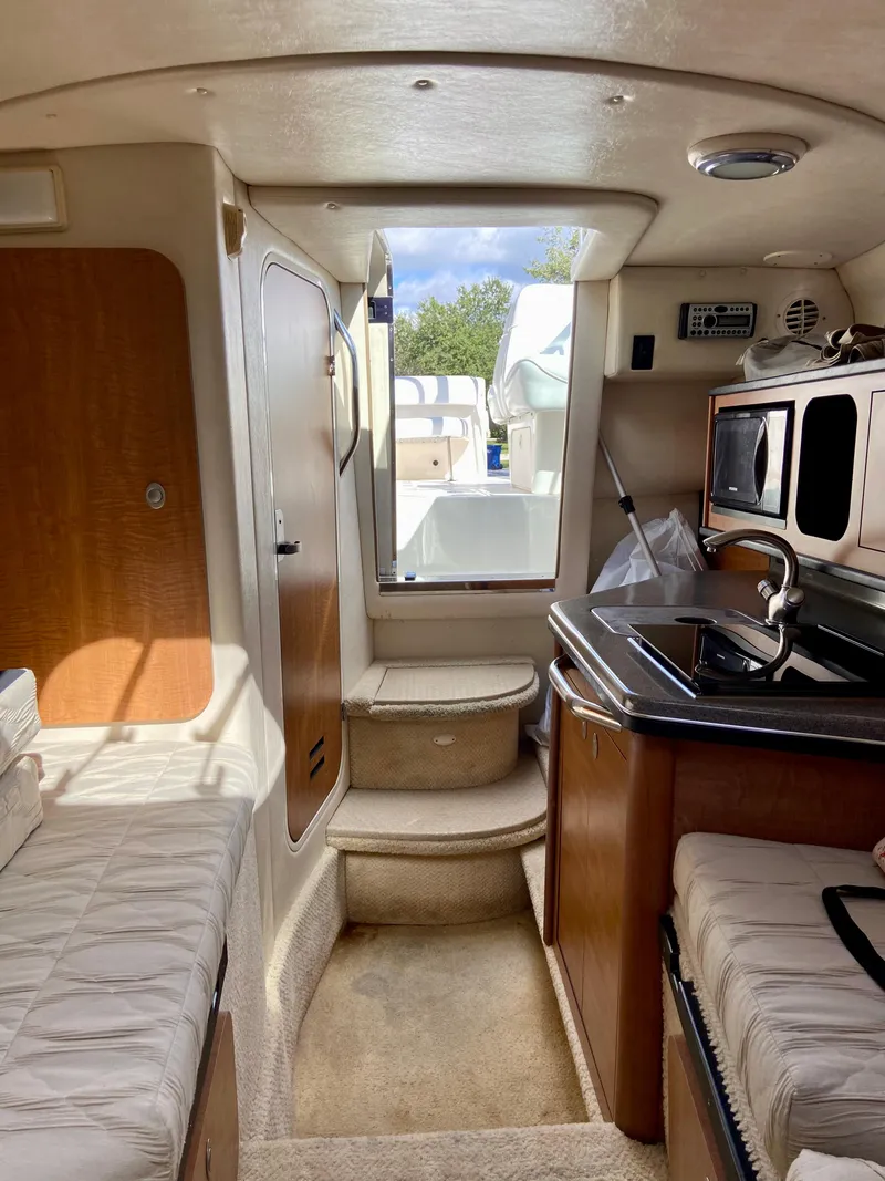 Slide: The Image of Interior of 2006 Sea Ray 270 Amberjack boat with kitchenette and seating area. - 29