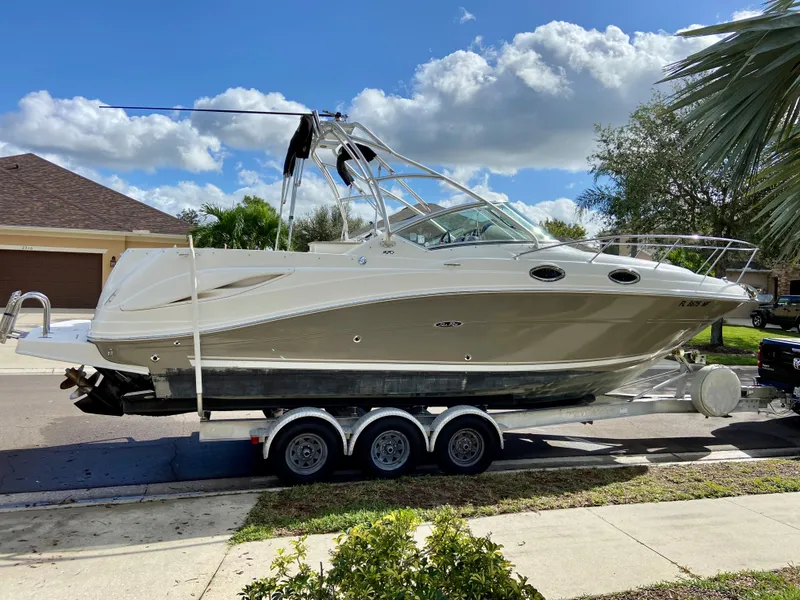 Slide: The Image of 2006 Sea Ray 270 Amberjack boat on trailer, parked in residential area. - 4