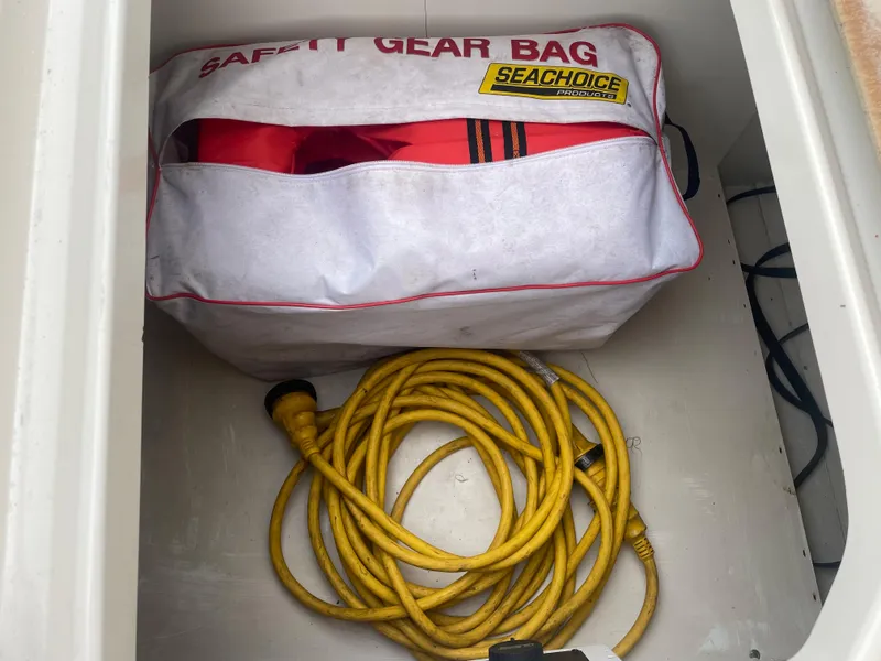 Slide: The Image of Safety gear bag and yellow rope in Sea Ray 270 Amberjack 2006 storage compartment. - 40