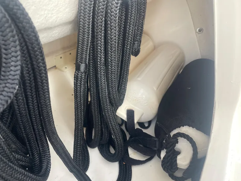 Slide: The Image of Ropes and fenders in a 2006 Sea Ray 270 Amberjack boat storage compartment. - 43