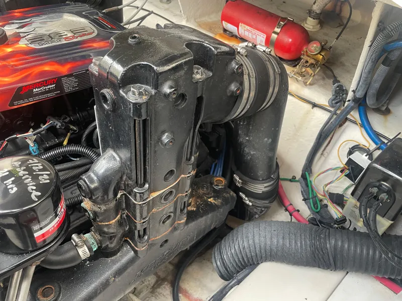 Slide: The Image of Engine compartment of 2006 Sea Ray 270 Amberjack with visible components and fire extinguisher. - 48