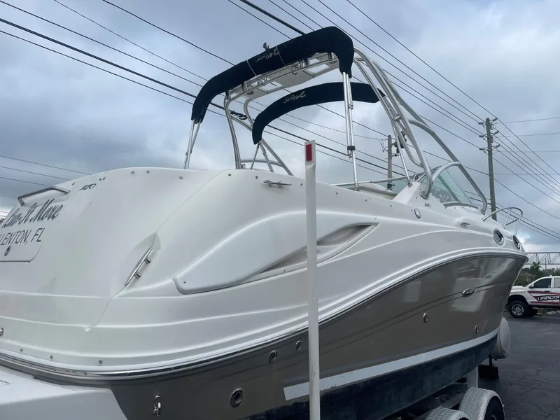 Slide: The Image of 2006 Sea Ray 270 Amberjack boat on trailer, overcast sky background. - 8