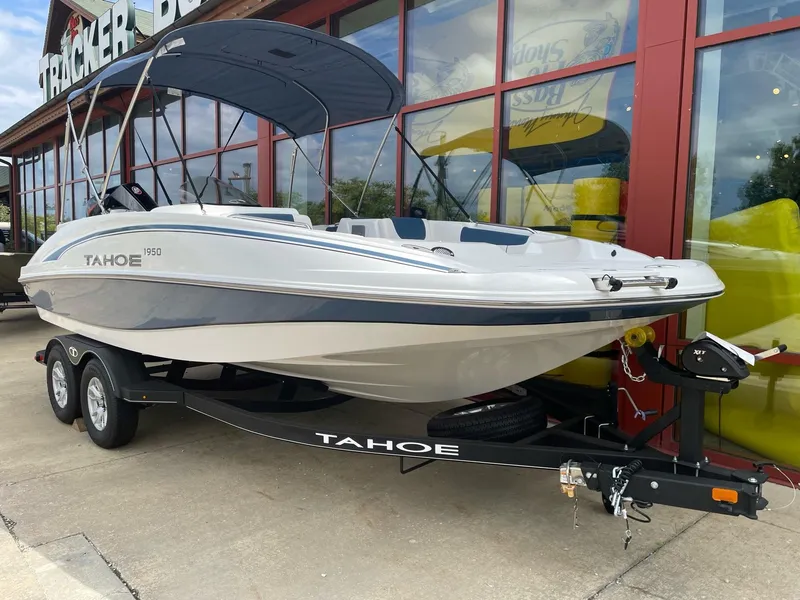 Slide: The Image of 2023 Tahoe 1950 boat on trailer outside a store. - 3