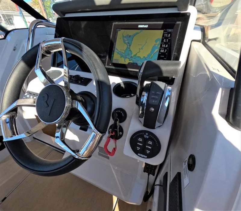 Slide: The Image of RYCK 280 boat dashboard with steering wheel and navigation display, 2023 model. - 10
