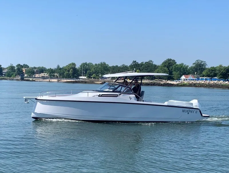 Slide: The Image of 2023 RYCK 280 boat cruising on calm water near a wooded shoreline. - 30