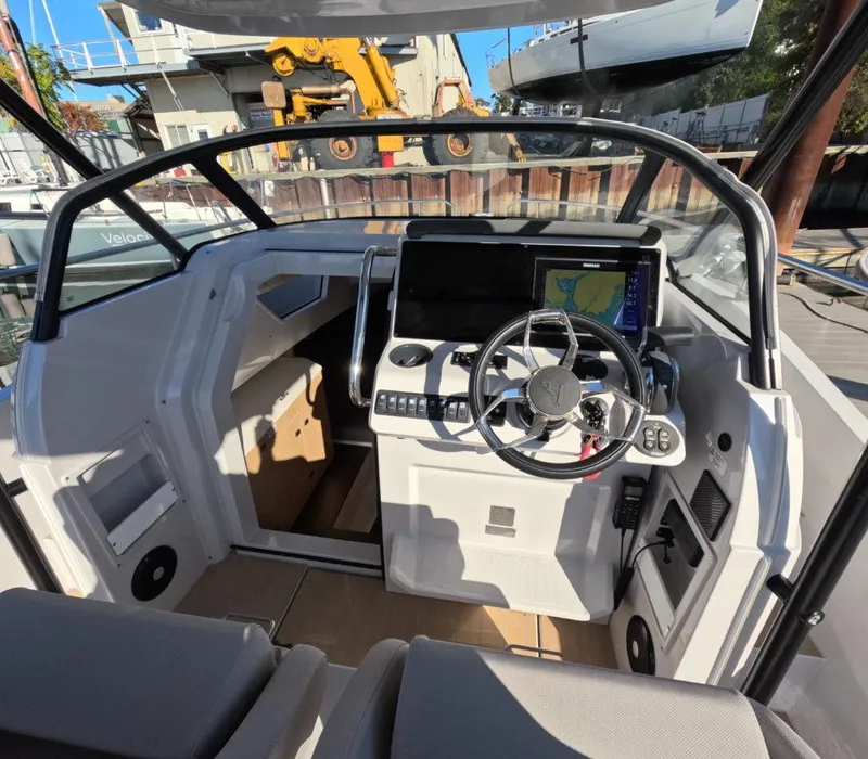 Slide: The Image of 2023 RYCK 280 boat cockpit with modern steering and navigation system. - 9