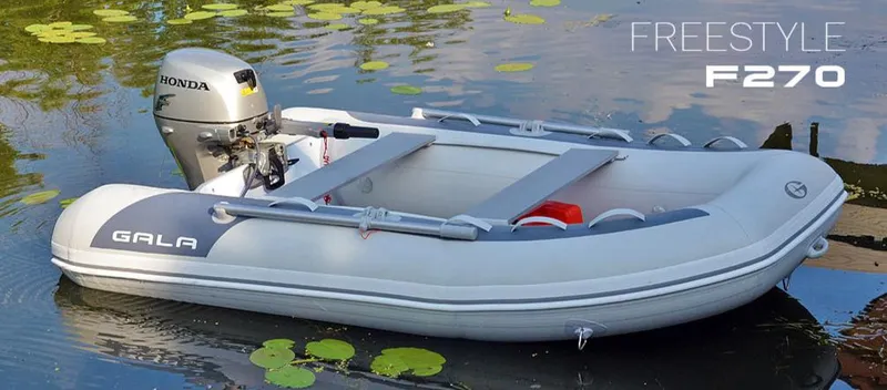 Slide: The Image of 2023 Gala F270A inflatable boat with Honda motor on a serene lake. - 6